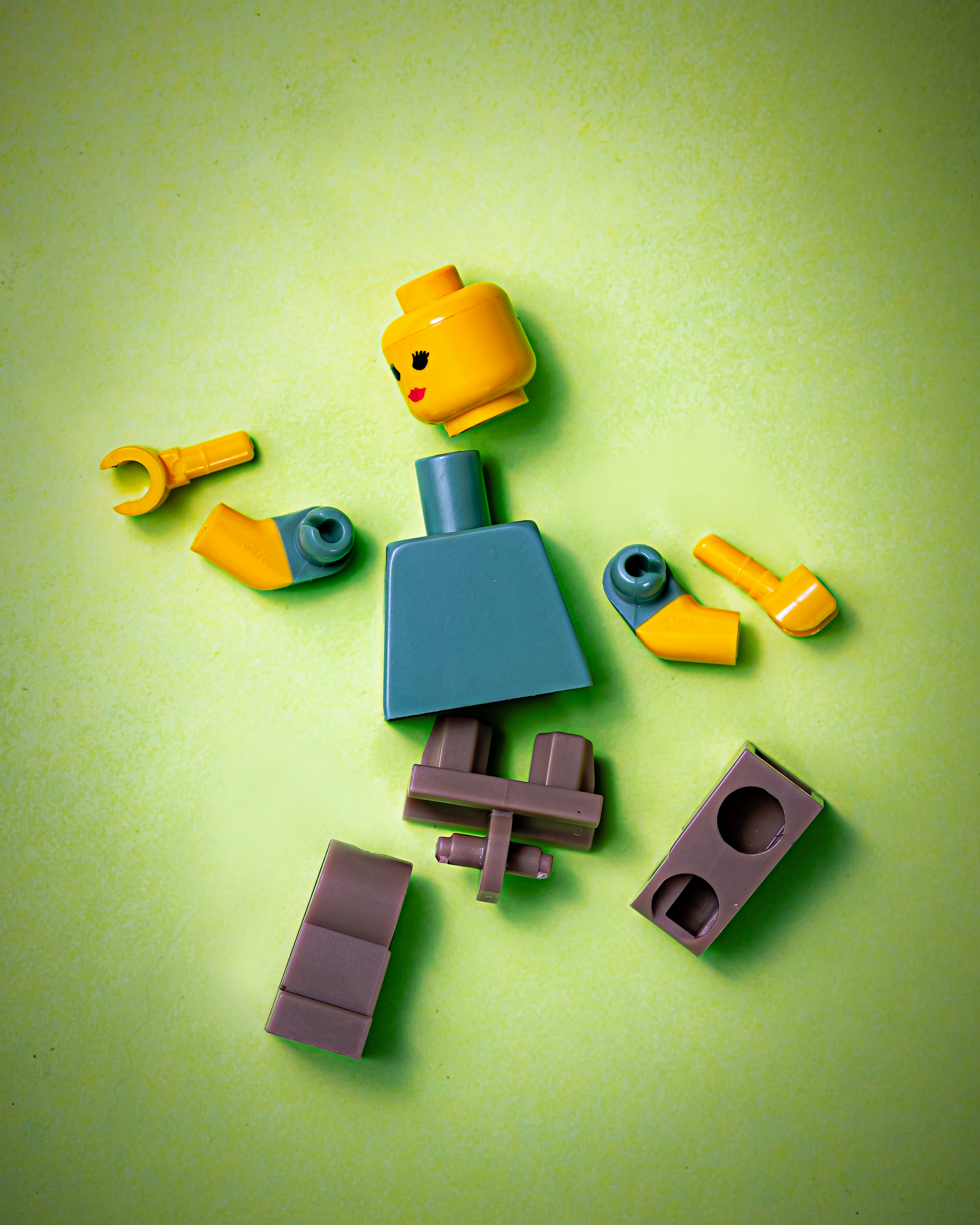Disassembled Lego figure representing the feeling of being broken apart by chronic illness