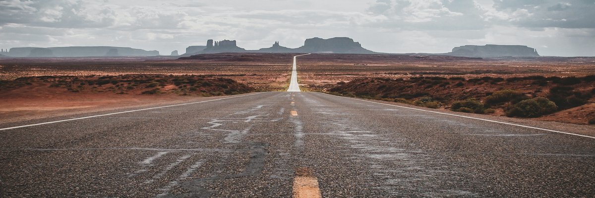 Open road stretching toward Monument Valley